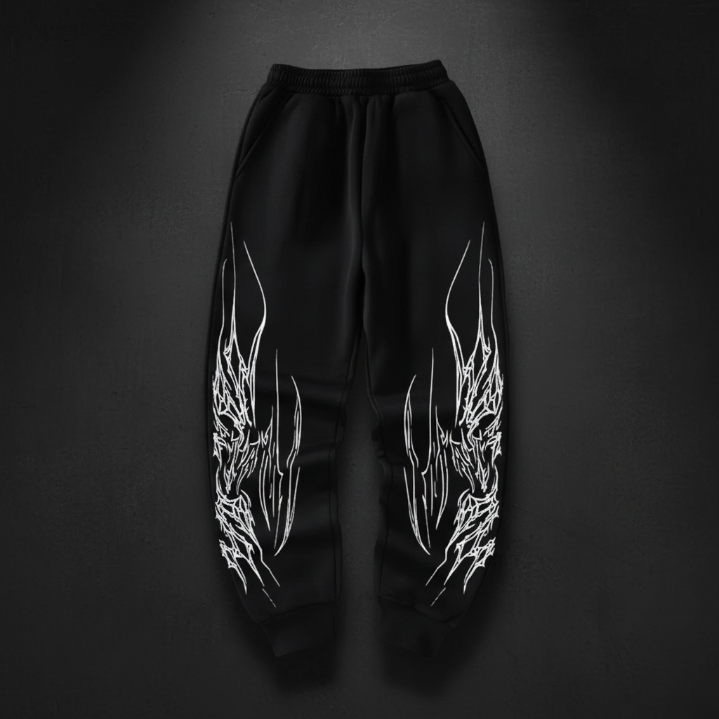 Black joggers with white dragon flames on dark background