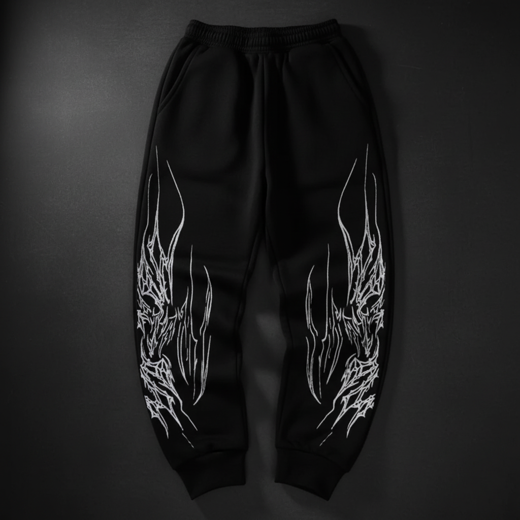 Black joggers with white dragon flames on dark background